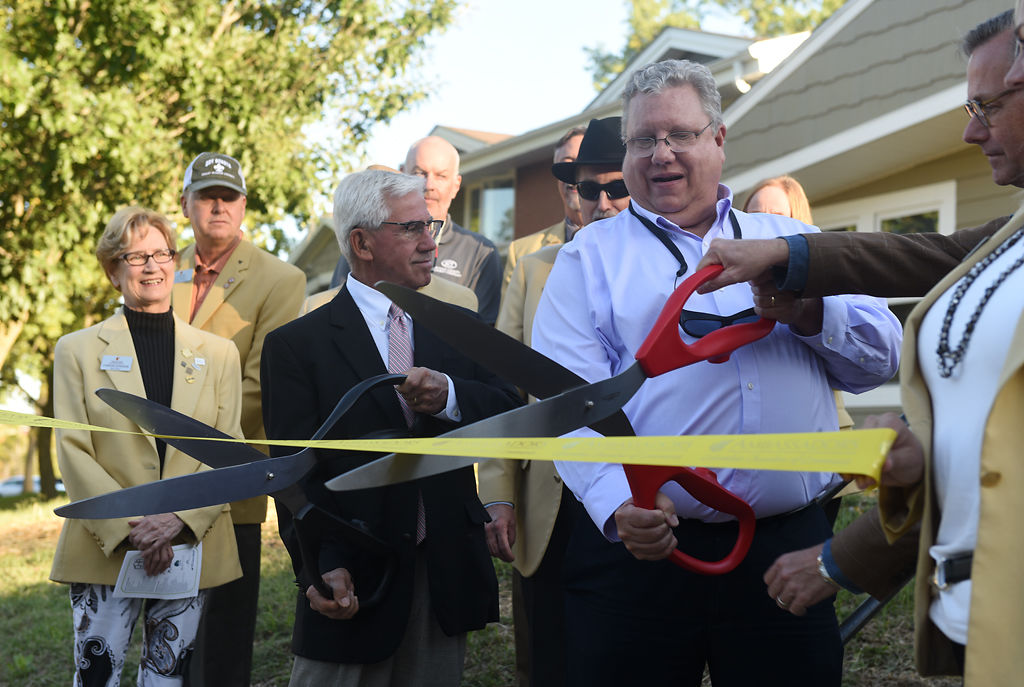 From left, Bob Hutton, Phil Steinhaus and Mayor Brian Treece cut a ribbon
